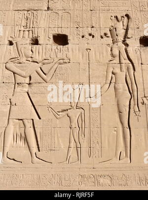 King in front of goddess; depicted on a wall relief at the Temple of Hathor, Dendera, Egypt Stock Photo