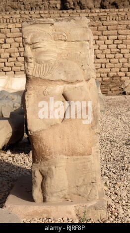 Relief sculpture of the Egyptian God, Bes in the forecourt of the Hathor Temple at Dendera. The dwarf-like god was seen as the protector of pregnant women, new-born babies and the family. The relief dates to the Ptolemaic-Roman period Stock Photo