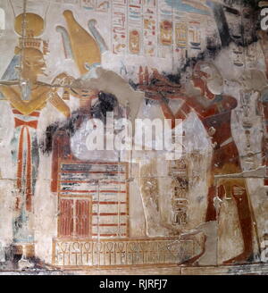 Abydos, one of the oldest cities of ancient Egypt; King Seti I, Presenting offering to Osiris and Isis Stock Photo