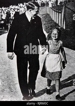 Adolf Hitler (1889 - 1945); German politician, demagogue. leader of the Nazi Party, with a typical Aryan child. Germany as Chancellor in 1933 and Fuhrer ('Leader') in 1934. dictator of Nazi Germany from 1933 to 1945, Stock Photo