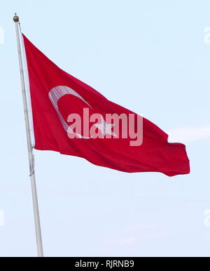 The flag of the Republic of Turkey, is a red flag featuring a white star and crescent. The flag is often called al bayrak (the red flag), and is referred to as al sancak (the red banner) in the Turkish national anthem. The current design of the Turkish flag is directly derived from the late Ottoman flag, which had been adopted in the late 18th century and acquired its final form in 1844. Stock Photo