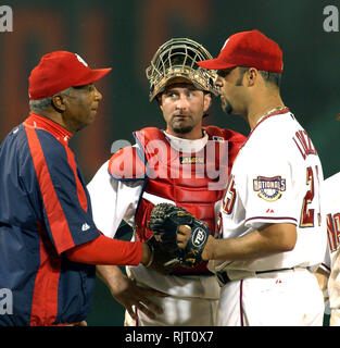 Washington, District of Columbia, USA. 5th July, 2005. Washington, DC - July 5, 2005 -- Washington Nationals manager Frank Robinson, left, congratulates starting pitcher Esteban Loaiza (21), right, as he removes him for a relief pitcher in the ninth inning against the New York Mets at RFK Stadium in Washington, DC on July 5, 2005. Nationals catcher Brian Schneider (23) looks on from center. The Nationals withstood a ninth inning rally and beat the Mets 3 to 2 Credit: Ron Sachs/CNP/ZUMA Wire/Alamy Live News Stock Photo