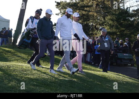 7th February, 2019  Monterey Peninsular Country Club, CA, USA  Jake Owen(pink trousers) Dustin Johnson and Jordan Spieth walk of the first tee of their first round at  the AT&T Pro-Am at Pebble Beach Golf Links Stock Photo