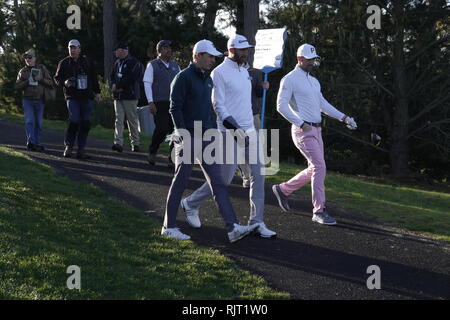 7th February, 2019  Monterey Peninsular Country Club, CA, USA  Jake Owen(pink trousers) Dustin Johnson and Jordan Spieth walk of the first tee of their first round at  the AT&T Pro-Am at Pebble Beach Golf Links Stock Photo