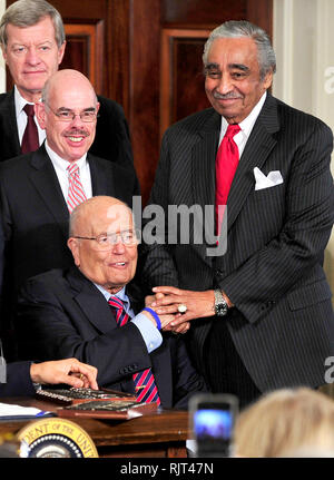 Washington, DC - March 23, 2010 -- United States Representative Charlie Rangel (Democrat of New York), right, shakes hands with U.S. Representative John Dingell (Democrat of Michigan), lower left, as U.S. President Barack Obama (not pictured) signs the version of the health care bill that was passed by the U.S. House of Representatives in the East Room of the White House in Washington, DC on Tuesday, March 23, 2010. U.S. Senator Max Baucus (Democrat of Montana), upper left, and U.S. Representative Henry Waxman (Democrat of California), center left, look on.Credit: Ron Sachs/CNP.(RESTRI Stock Photo