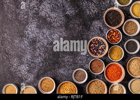 Set of different superfoods- whole grains, beans and legumes, seeds and nuts, top view. Stock Photo