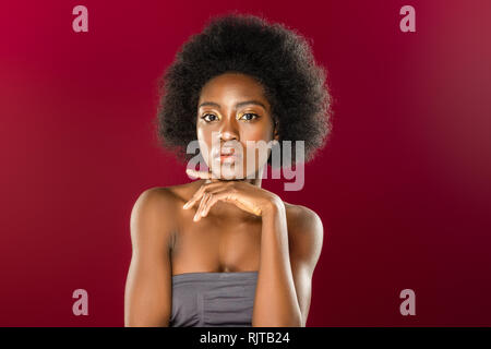 Beautiful nice young woman touching her chin Stock Photo