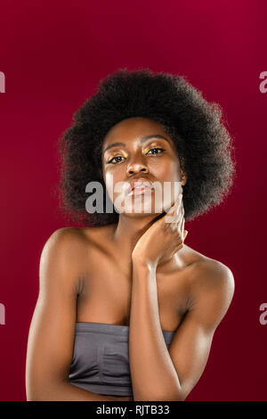 Attractive dark haired woman touching her neck Stock Photo