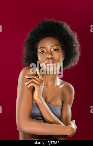 Pleasant nice young woman touching her arm Stock Photo