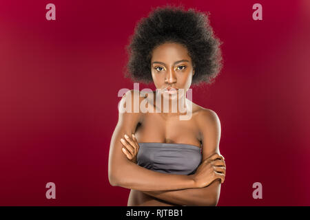 Beautiful serious young woman standing cross handed Stock Photo