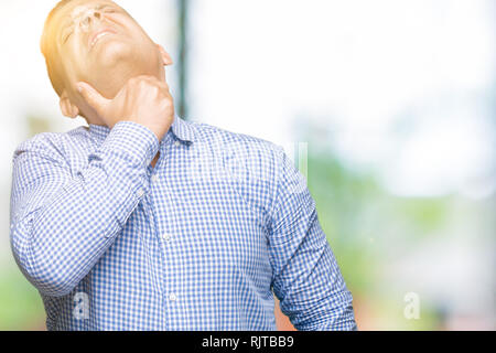 Middle age arab business man over isolated background Touching painful neck, sore throat for flu, clod and infection Stock Photo