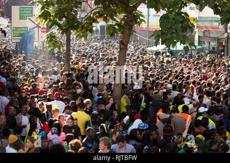 People gather for the annual 'Brixton Splash,' to mark Jamaican Independence Day on August 5, 2012 in London. Stock Photo