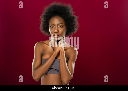 Nice pleasant young woman touching her neck Stock Photo