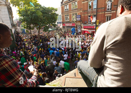 People gather for the annual 'Brixton Splash,' to mark Jamaican Independence Day on August 5, 2012 in London. Stock Photo