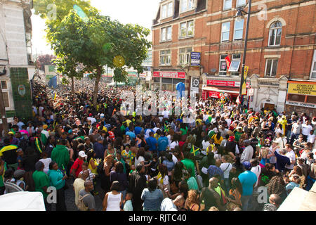 People gather for the annual 'Brixton Splash,' to mark Jamaican Independence Day on August 5, 2012 in London. Stock Photo