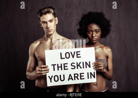 Good looking nice people standing against dark background Stock Photo