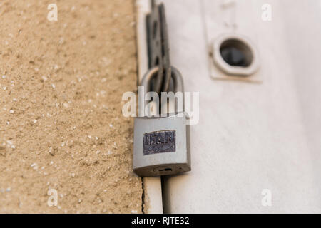 An IFAM lock closes the door of an electrical panel in Caceres, Extremadura, Spain. Stock Photo