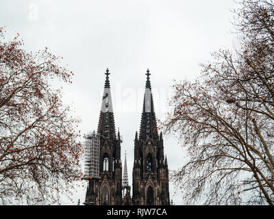 Minimalist shot of gothic Cologne Cathedral in Germany with scaffold against cloudy sky Stock Photo