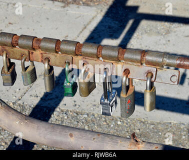 Multiple locks on a security gate. The removal of any one lock allows ...