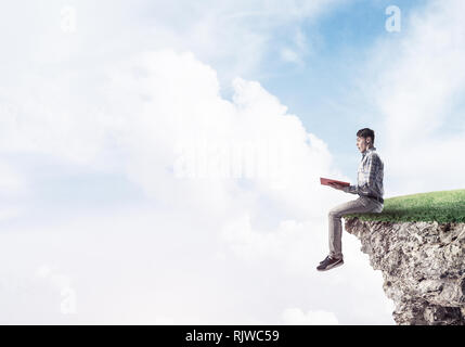 Student guy with book in hands preparing for exam Stock Photo