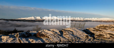 Far-reaching panorama above the cloud inversion of the snow covered fells from Orrest Head, Windermere, on a cold, crisp winter's morning Stock Photo