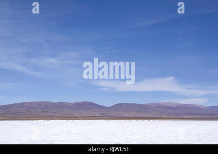 Salinas grandes and salt mining area in northern Argentina, Jujuy region on a sunny day with mountains in the background Stock Photo
