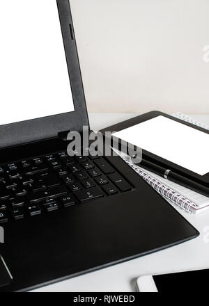 Office desk with laptop computer, tablet pc, planner, pen and mobile smartphone. Close up Stock Photo