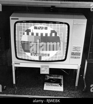 Television in the 1970s. Still a black and white image only on this tv set from 1975 for sale at 1095 SEK. Perhaps the last of this tv sets for sale as the folder lying below is an advertisment for the color tv. Stock Photo