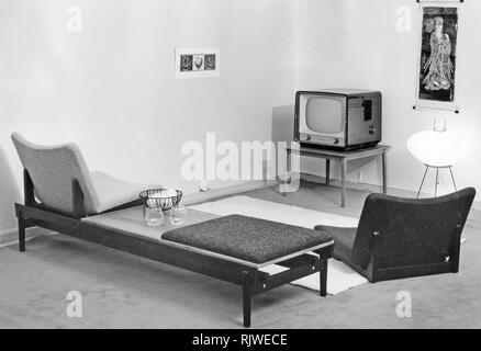 Television in the 1950s A tv set on a small table in a room. In home decorating new and suitable furniture focused on and around the tv. The chairs and table are positioned with the tv in mind. Sweden 1957 Stock Photo