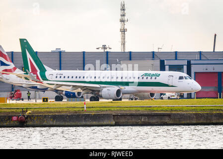 London, England. February 2018. Embraer ERJ-190STD Alitalia Cityliner EI-RNA departing from London City Airport (LCY) Stock Photo