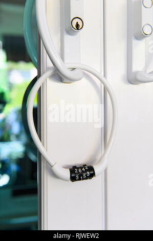 Door locked with number combination padlock Stock Photo