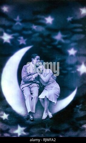 Early Montage, Lovers sitting on the crescent moon, 1920s, Germany Stock Photo