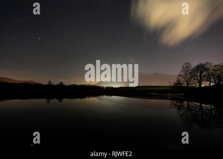 Star trails over Derwentwater, Keswick town, Lake District National Park, Cumbria County, England. Stock Photo