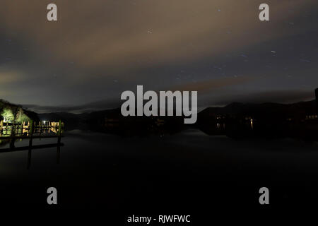Star trails over Derwentwater, Keswick town, Lake District National Park, Cumbria County, England. Stock Photo