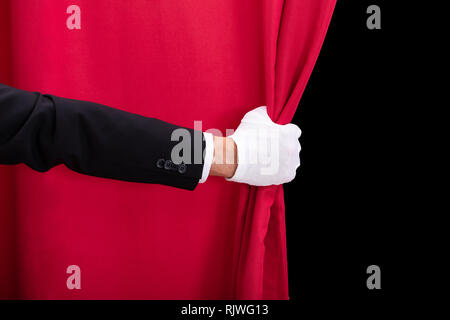 Close-up Of Two Men's Hand Opening Red Curtain Stock Photo