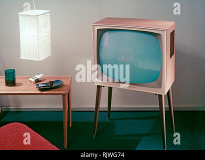 Television in the 1950s. A Grundig television set that was available for customers 1957. A typical 1950s design with a wooden case standing on thin legs. ref BV20-3 Stock Photo