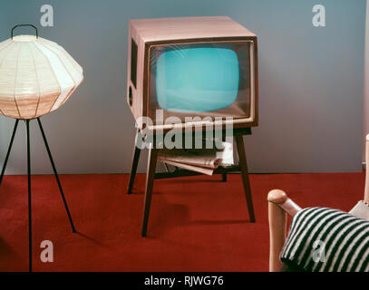 Television in the 1950s. A Grundig television set that was available for customers 1957. A typical 1950s design with a wooden case standing on thin legs. ref BV65-3 Stock Photo