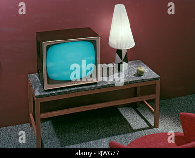 Television in the 1950s. A Grundig television set that was available for customers 1957. A typical 1950s design with a wooden case standing on thin legs. ref BV65-2 Stock Photo