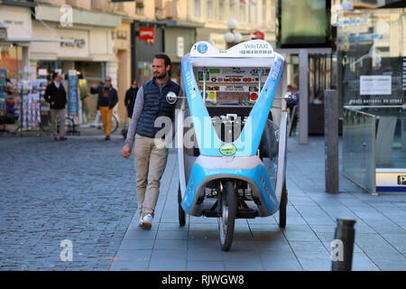 Nice, France - February 6 2019: Cycle Rickshaw (Happymoov Company) Driver Waiting For Customers On Massena Square (Place Massena) In Nice, French Rivi Stock Photo