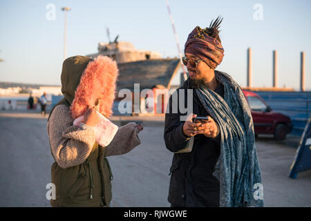Young Asian Bearded Tourist man with Dreadlocks and scarf on head Having Fun in Essaouira, Morocco at the evening sunset time. Stock Photo