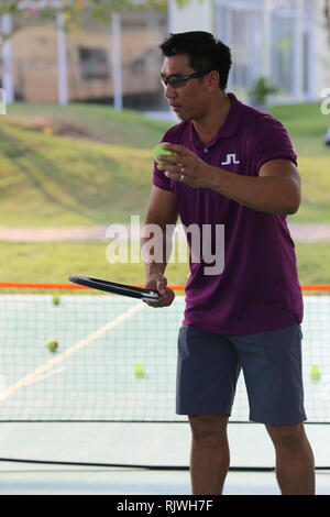 Internationally renowned Thai former tennis champion Paradorn Srichaphan coaches young students at an international school in Hua Hin. Stock Photo