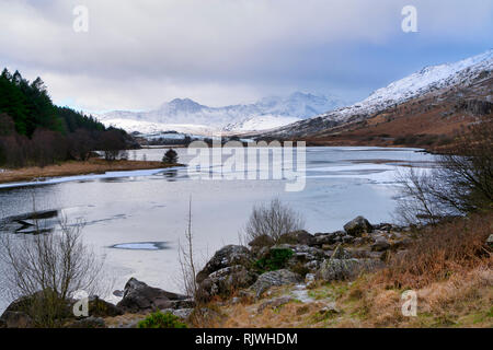A view towards the snow capped Snowdon Horseshoe from Llyn (Lake) Mymbyr in Capel Curig, Wales, UK Stock Photo