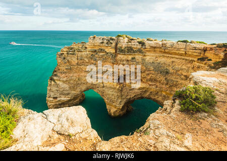 Natural arches underneath rugged cliffs, Praia da Marinha, Algarve, Portugal, Europe Stock Photo