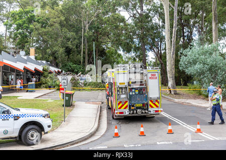 Sydney fire brigade and sydney police block off a road where a tree has fallen on parked cars,Sydney,Australia Stock Photo