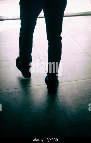 Silhouette of a man walking away Stock Photo