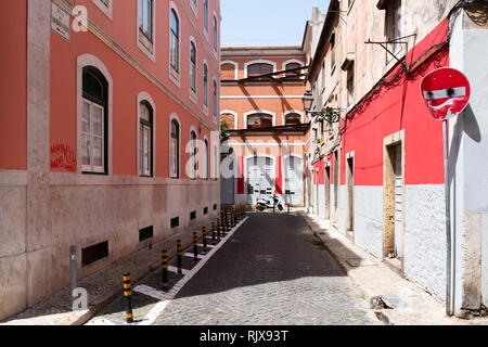 Small alley with red and white walls. Stock Photo