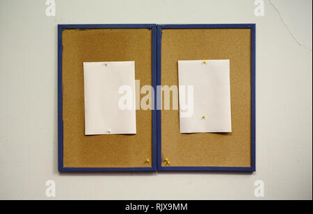 Simple composition, two frames of cork with blank white papers on wall. Stock Photo
