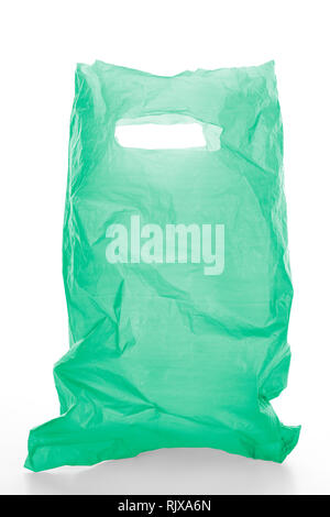 Empty green plastic garbage bag isolated on white background, clipping path around the bag and the handle, not around the cast shadow, included. Stock Photo
