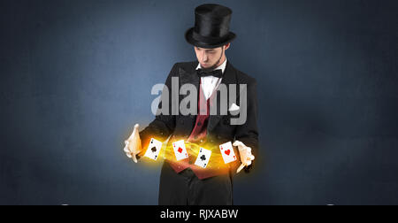 Illusionist in tails bandy play cards between his two hands Stock Photo ...