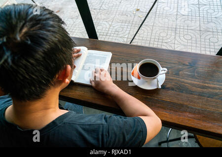 Asian man read book in the nice morning Stock Photo